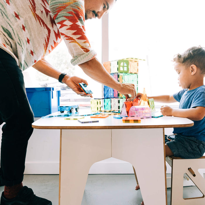 2 year old playing with building tiles 